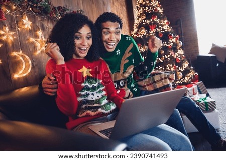 Photo of excited people friends sit sofa in illuminated light house room browsing web netbook for incredible tradition x mas season discounts
