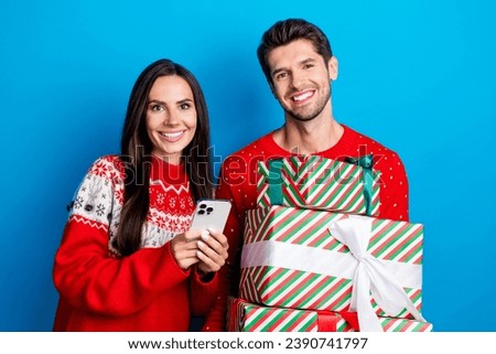Photo portrait of lovely young spouses hold presents boxes pile device wear x-mas ornament red sweaters isolated on blue color background