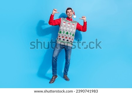 Full length photo of assertive perky funky guy wear christmas hat print waistcoat directing at himself isolated on blue color background