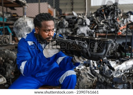 Auto mechanic in blue uniform are repair and maintenance auto engine is problems at car repair shop.