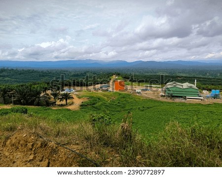 Palm plantation Lanscapes view at east Kalimantan taken from the  hills,beauty nature with cloudy sky Royalty-Free Stock Photo #2390772897