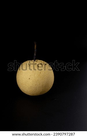 shriveled pears on a black background