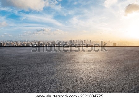 Asphalt road platform and city skyline with skyscraper at sunset in Shanghai, China. High Angle view. Royalty-Free Stock Photo #2390804725