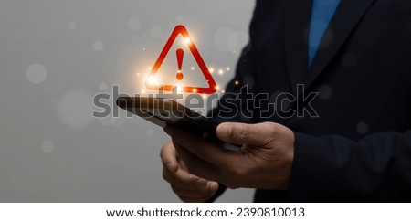 Businessman using smartphone with red triangle warning sign for error notification and maintenance concept