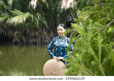 A young girl is wearing Vietnamese traditional style clothes, Nguyen Dynasty, Tran Dynasty. Video for tourism, culture, tradition, and the beauty of Asian people