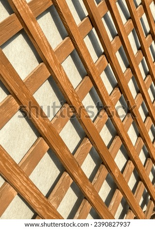 Wooden lattice on the wall as an abstract background. Texture.