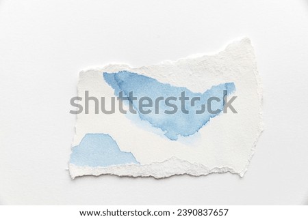 Paper different shapes scraps. white torn piece of paper with blue watercolor streaks on a white background. Top View of Blank. Blank Note with Copy Space for Text, Image. Social Media concept.
