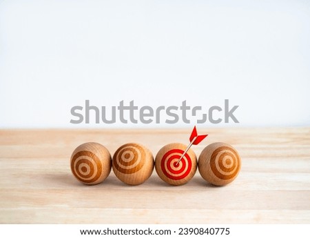 Focus on the right target, objective, business goals concepts. Red bullseye icon on wooden sphere ball with arrow on red spot, dartboard, isolated on white background with copy space, minimal style. 
