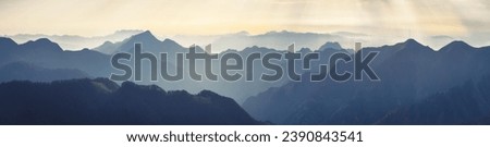 Mountain range with visible silhouettes through the morning fog. Traveling along the mountains, freedom and active lifestyle concept. Vibrant photo wallpape. Natural background. Panorama  Carpathian