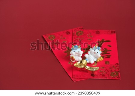 Happy New Year Chinese of the dragon 2024. Rabbit on red envelopes and gold ingot isolated on red background. The word inside picture means blessing.