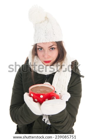 Portrait of a girl with winter coat mittens and cap and mug hot chocolate