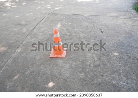 traffic cone on cement concrete sidewalk road.