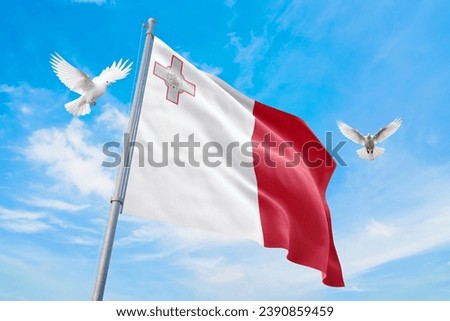 Waving flag of Malta in beautiful sky and flying pigeons. Malta flag for independence day. The symbol of the state on wavy fabric.