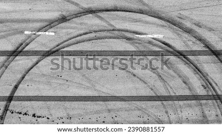 Aerial top view auto tire tread element, Car tire pattern, Wheel tyre tread track, Black tyre print on asphalt road. Royalty-Free Stock Photo #2390881557