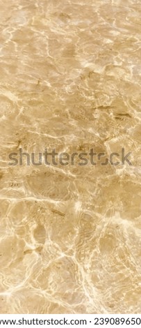 The water is so clear you can see the sand beneath.  and the light that falls on it causes a watermark.