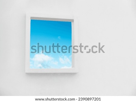 White Wall texture of concrete with open window against blue sky and clouds inSummer, Exterior Cement building with border frame with Spring sky,Ant view Modern architecture. Minimal design