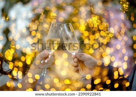 Two glasses with sparkling champagne in hands, Celebration.