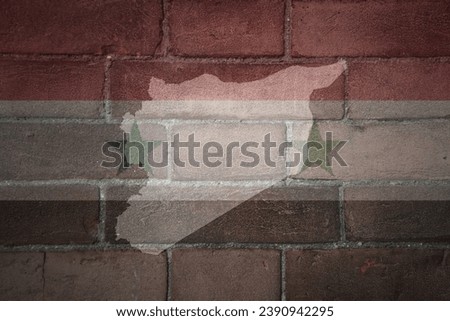 painted map and flag of syria on a old brick wall