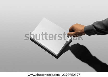 Book mockup template, real photo, man's hand opening a book. Sharp shadows, blank, isolated on a white background to place your design. 