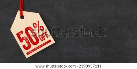 Tag on a blackboard - 50 percent off Royalty-Free Stock Photo #2390957111