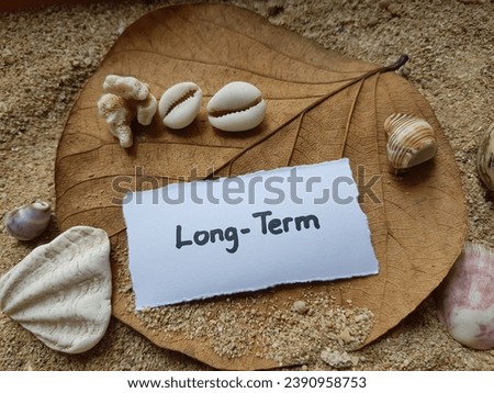 Long term writing on beach sand background.