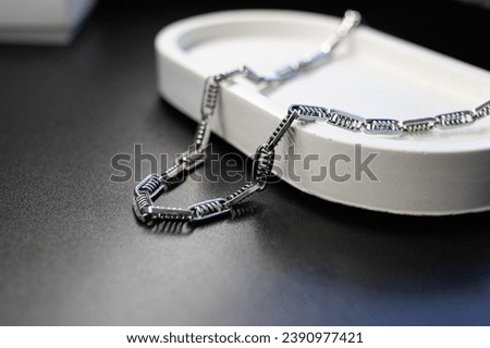 Silver chain of unusual shape, jewelry subject photography