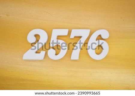 The golden yellow painted wood panel for the background, number 2576, is made from white painted wood.