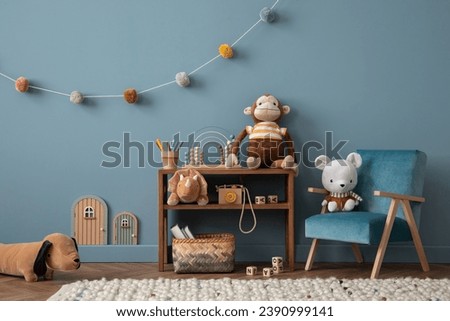 Warm and cozy living room interior with blue wall, rattan sideboard, stylish armchair, plush whale, mouse, toys, guitar, ornament on wall, braided rug and personal accessories. Home decor. Template.