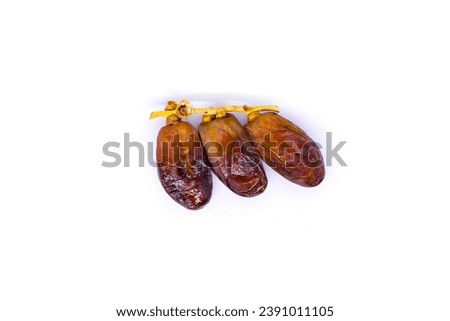 Creative layout made of stemmed dates or three dates fruits with stem isolated on a white background. Ramadan Arabic food concept. A palm date that is widely grown in Africa and is good for health.