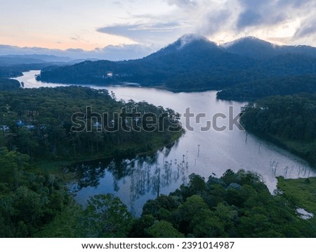 Aerial view of morning on Tuyen Lam lake at Dalat, Vietnam, beautiful landscape for eco travel at Vietnam, amazing lake among pine forest, boat on water, Da Lat countryside is famous place for holiday