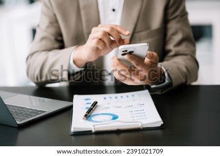 Confident businessman working on laptop,tablet and smartphone at her workplace at modern office.
