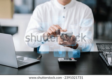 Asian Businessman working with smart phone and laptop and digital tablet computer in office with digital marketing media in virtual icon
