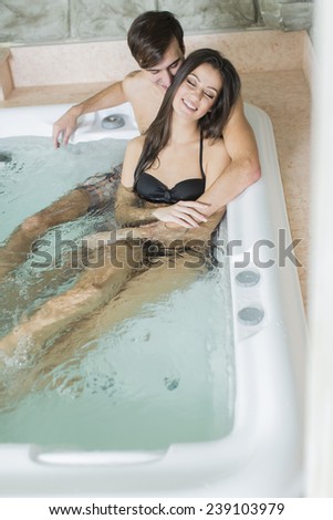 Young couple relaxing in the hot tub
