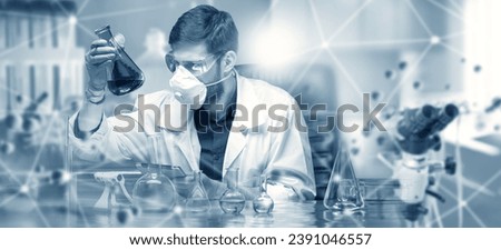 Man scientist. Virologist sits at table with test tubes and microscope. Guy scientist in white coat. Laboratory assistant does scientific research. Man scientist at work. Biologist in protective mask Royalty-Free Stock Photo #2391046557