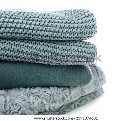 Different soft folded blankets on white background, closeup