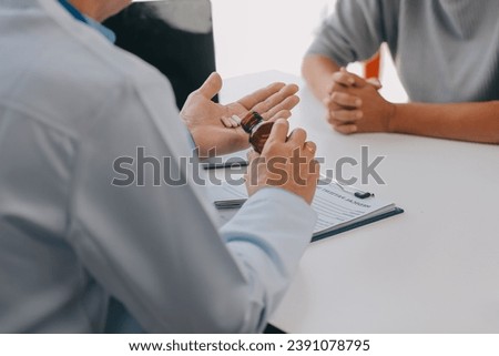 Doctor giving hope. Close up shot of young female physician leaning forward to smiling elderly lady patient holding her hand in palms. Woman caretaker in white coat supporting encouraging old person Royalty-Free Stock Photo #2391078795