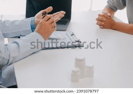 Doctor giving hope. Close up shot of young female physician leaning forward to smiling elderly lady patient holding her hand in palms. Woman caretaker in white coat supporting encouraging old person Royalty-Free Stock Photo #2391078797
