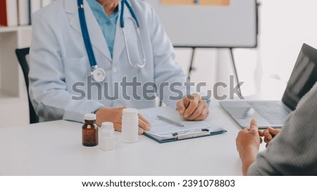 Doctor giving hope. Close up shot of young female physician leaning forward to smiling elderly lady patient holding her hand in palms. Woman caretaker in white coat supporting encouraging old person Royalty-Free Stock Photo #2391078803