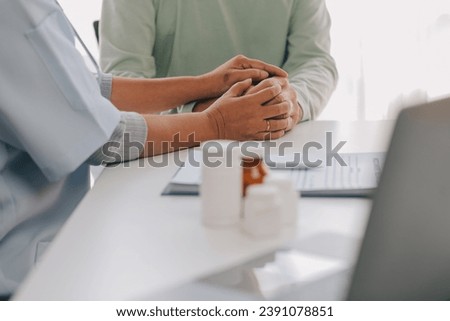 Doctor giving hope. Close up shot of young female physician leaning forward to smiling elderly lady patient holding her hand in palms. Woman caretaker in white coat supporting encouraging old person Royalty-Free Stock Photo #2391078851