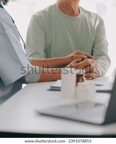 Doctor giving hope. Close up shot of young female physician leaning forward to smiling elderly lady patient holding her hand in palms. Woman caretaker in white coat supporting encouraging old person Royalty-Free Stock Photo #2391078853