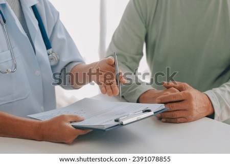 Doctor giving hope. Close up shot of young female physician leaning forward to smiling elderly lady patient holding her hand in palms. Woman caretaker in white coat supporting encouraging old person Royalty-Free Stock Photo #2391078855