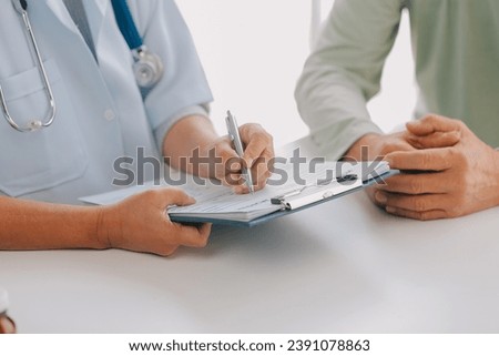 Doctor giving hope. Close up shot of young female physician leaning forward to smiling elderly lady patient holding her hand in palms. Woman caretaker in white coat supporting encouraging old person Royalty-Free Stock Photo #2391078863