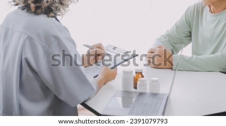 Mature Asian male doctor talking with his patient, explaining the procedure to old lady.