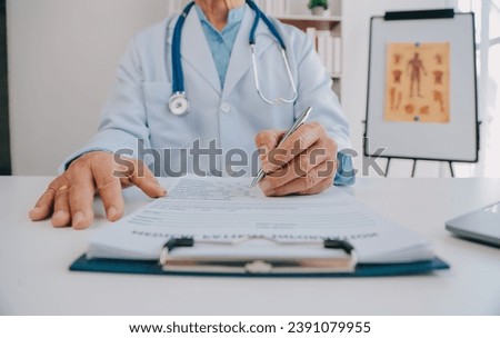Doctor giving hope. Close up shot of young female physician leaning forward to smiling elderly lady patient holding her hand in palms. Woman caretaker in white coat supporting encouraging old person Royalty-Free Stock Photo #2391079955