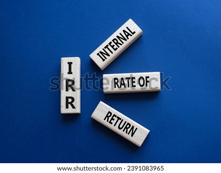 IRR - Internal Rate of Return symbol. Concept word IRR on wooden cubes. Beautiful deep blue background. Business and IRR concept. Copy space.