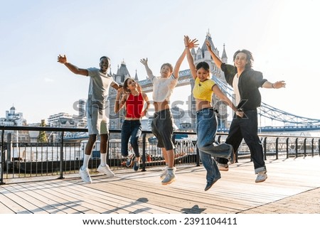 Multiracial group of happy young friends bonding in London city - Multiethnic teens students meeting and having fun in Tower Bridge area, UK - Concepts about youth lifestyle, travel and tourism Royalty-Free Stock Photo #2391104411
