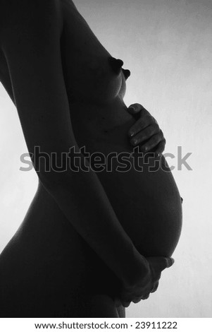 Silhouette of the pregnant woman's belly