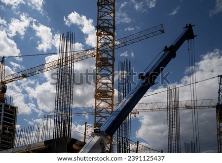 Cranes on a construction site. Industrial image