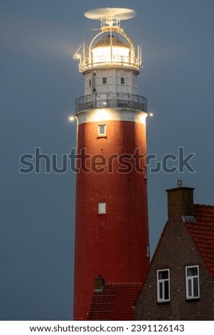 Lighthouse in the dark with the light shining