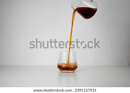 Pouring Coffee Pouring Tea Filter Coffee Into Nice Glass  Royalty-Free Stock Photo #2391127931
